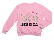 a pink sweatshirt with the name of a flower garden