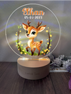 a glass ornament with a picture of a deer