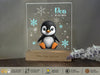 a penguin in a glass block with snowflakes