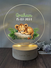 a glass plaque with a picture of a lion resting on a rock