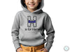 a young boy wearing a grey hoodie with the h is for harry on it