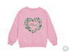 a pink sweatshirt with a heart and leaves on it