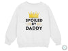 a white sweatshirt with the words spoiled by daddy and a crown on it